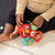 BABY EINSTEIN Igrača glasbena senzorična Roxy's Bright Flight™ 3m+