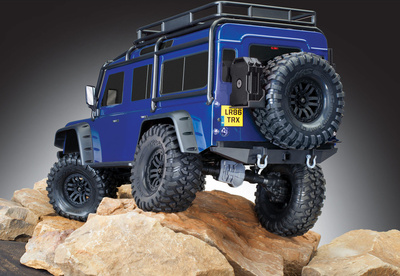 82056-4-Defender-Blue-3qtr-rear-rocks-studio.jpg