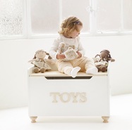 TV606-toy-chest-girl-sitting-with-plush-doll-friends.jpg